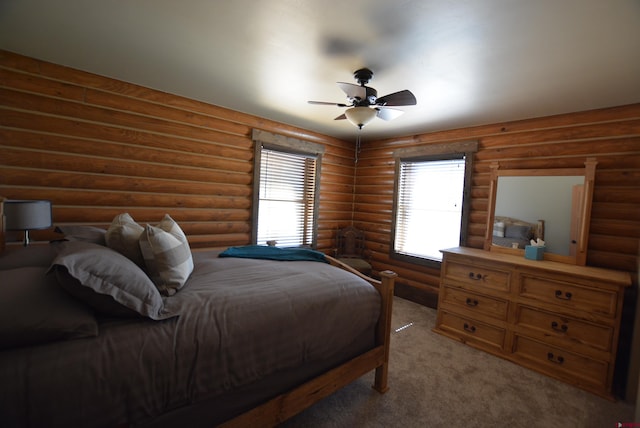 bedroom featuring carpet floors, rustic walls, and ceiling fan