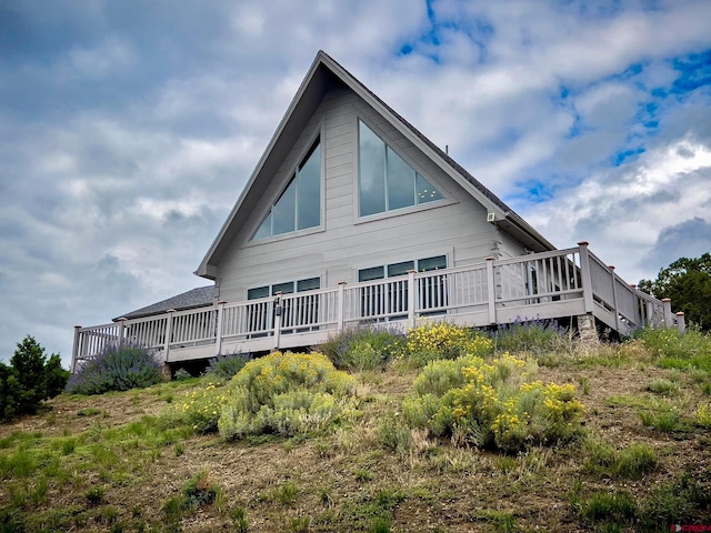 rear view of property with a wooden deck