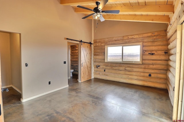 empty room with ceiling fan, rustic walls, vaulted ceiling with beams, a barn door, and wooden ceiling