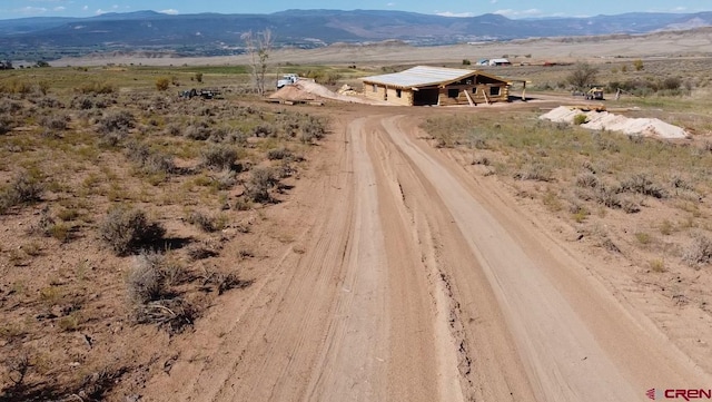 birds eye view of property featuring a mountain view