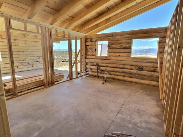 unfurnished room with lofted ceiling with beams, wood ceiling, and rustic walls