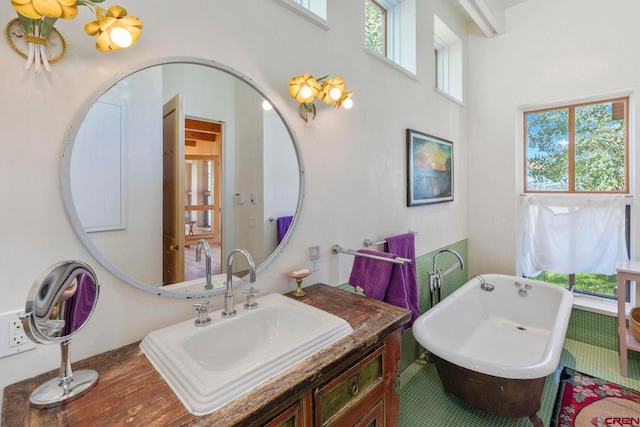 1006 Top Of The World Dr, Placerville, CO 81430 - bathroom with a healthy amount of sunlight, an inviting chandelier, vanity, and a tub