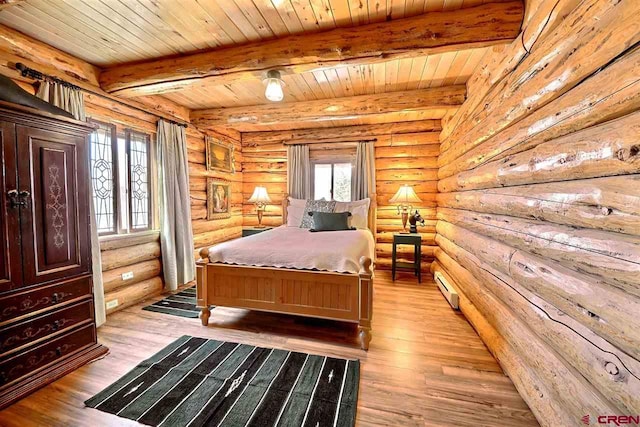 bedroom featuring beam ceiling, rustic walls, and light hardwood / wood-style floors