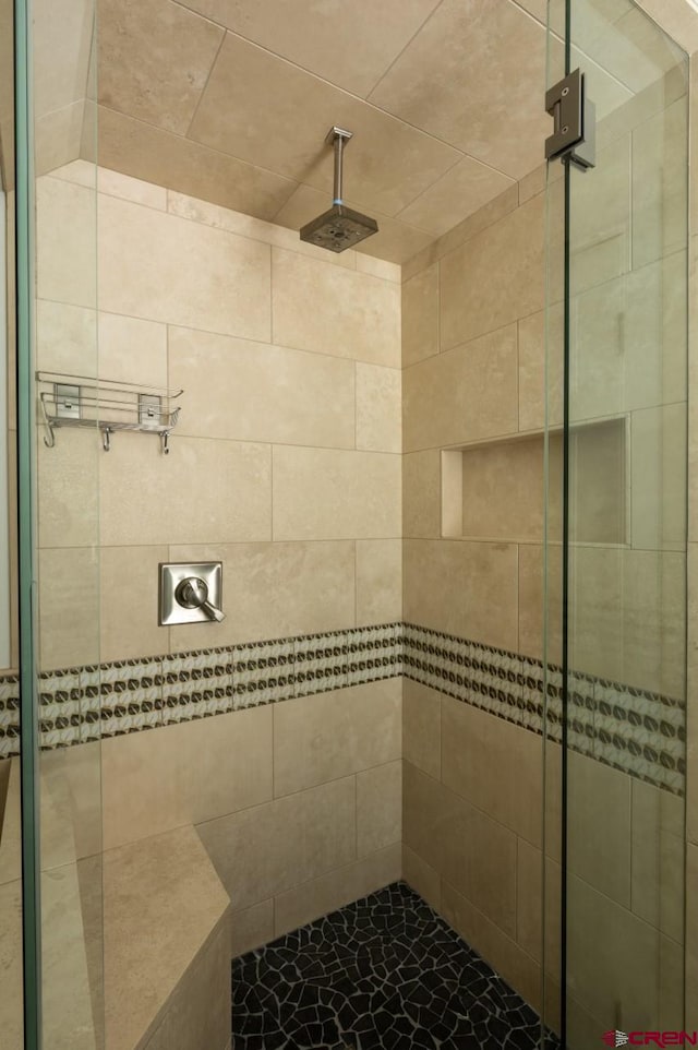 bathroom with a shower with door