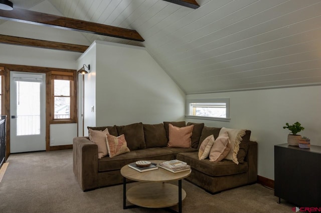 carpeted living room with vaulted ceiling with beams