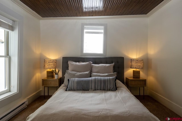 bedroom featuring baseboard heating, multiple windows, crown molding, and dark colored carpet