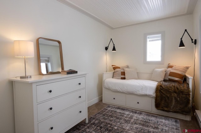 bedroom with baseboard heating and dark colored carpet