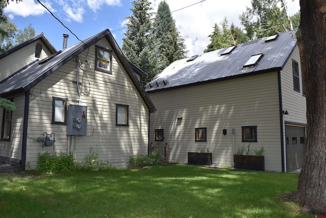 29 Whiterock Ave, Crested Butte, CO 81224 - back of property featuring a garage, a lawn, and metal roof