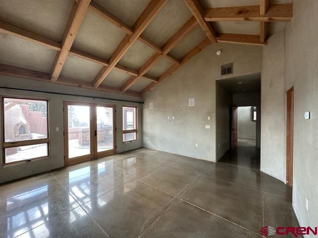 tiled empty room with high vaulted ceiling, french doors, and beamed ceiling