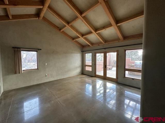 empty room featuring tile flooring, high vaulted ceiling, french doors, and beamed ceiling