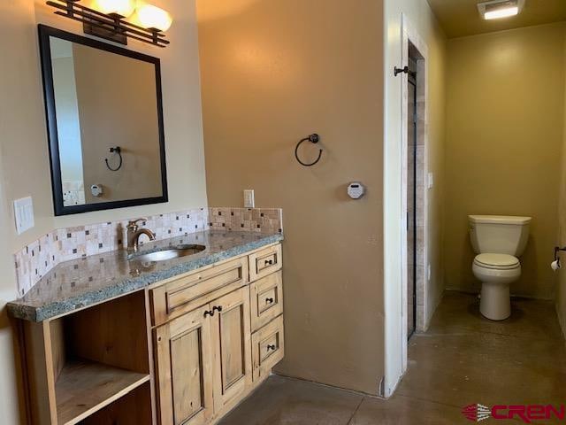 bathroom featuring tile floors, toilet, and vanity