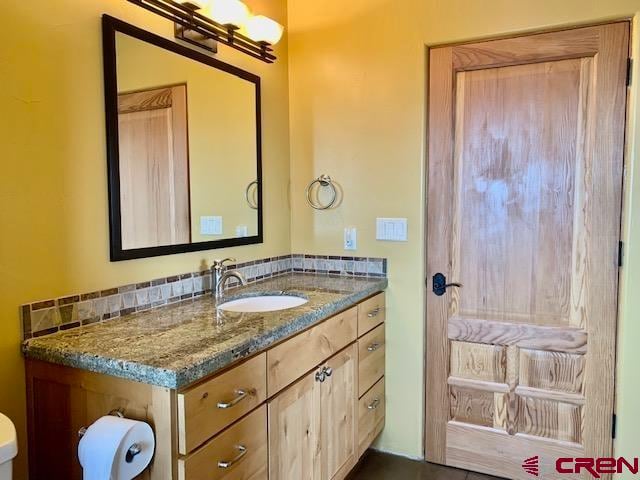 bathroom with toilet and vanity