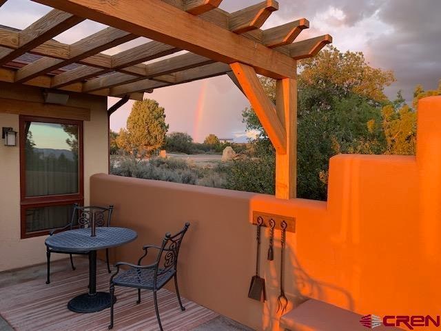 deck at dusk featuring a pergola