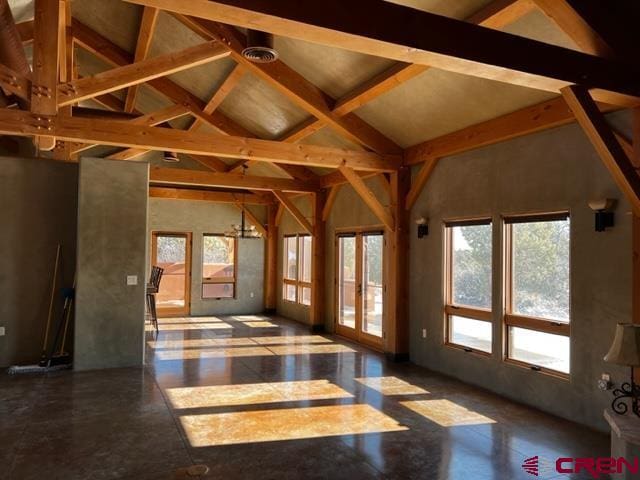 interior space with high vaulted ceiling, beam ceiling, and a chandelier