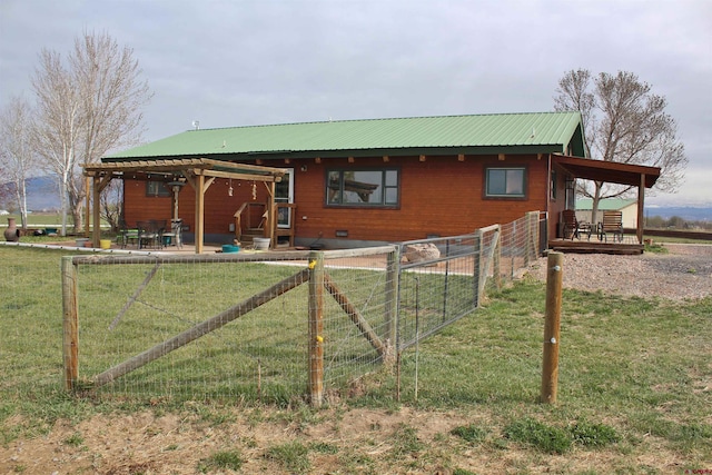 rear view of property featuring a patio and a yard