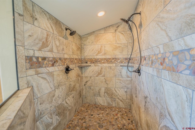 bathroom with a tile shower