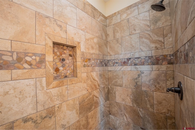 interior details featuring a tile shower