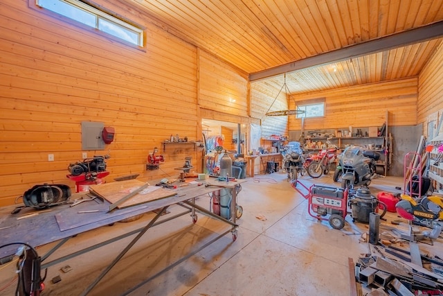 interior space with lofted ceiling, wood walls, a workshop area, and wooden ceiling