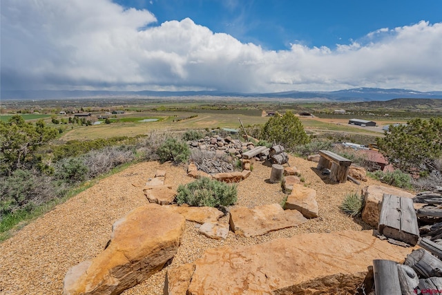 birds eye view of property with a rural view