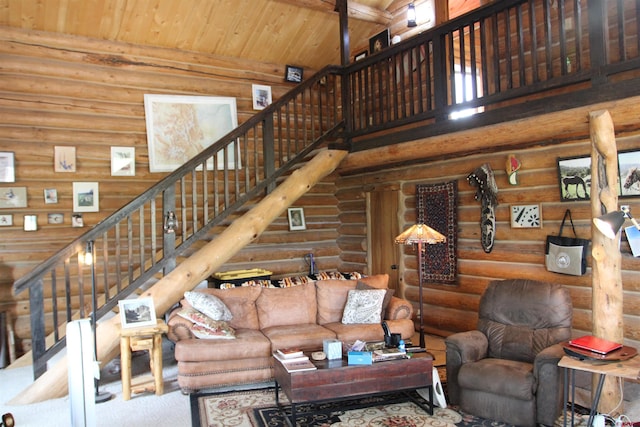 living room with log walls, beamed ceiling, wood ceiling, and a high ceiling