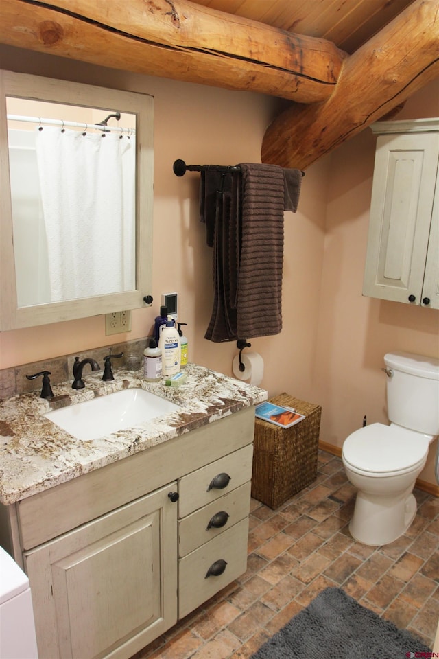 bathroom featuring toilet, oversized vanity, and wooden ceiling