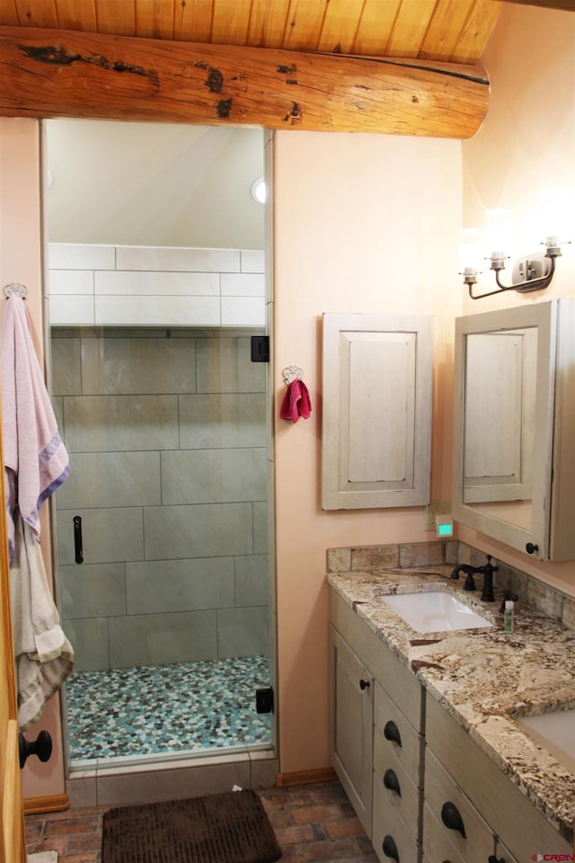 bathroom with wooden ceiling, dual bowl vanity, and a shower with door