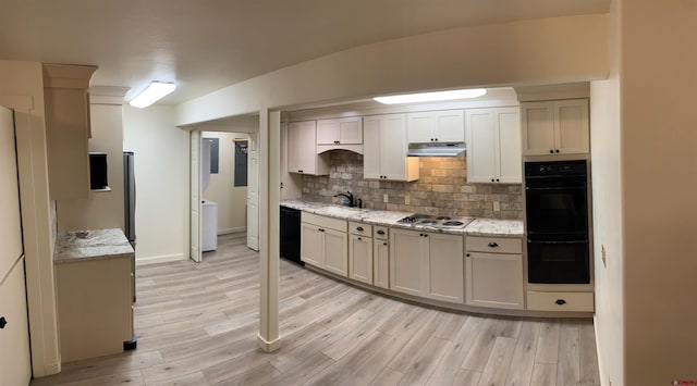 kitchen featuring light hardwood / wood-style flooring, backsplash, white cabinetry, and black appliances