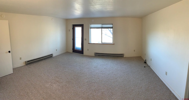 carpeted empty room with a baseboard heating unit