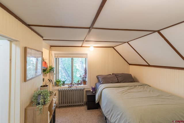 carpeted bedroom featuring lofted ceiling and radiator