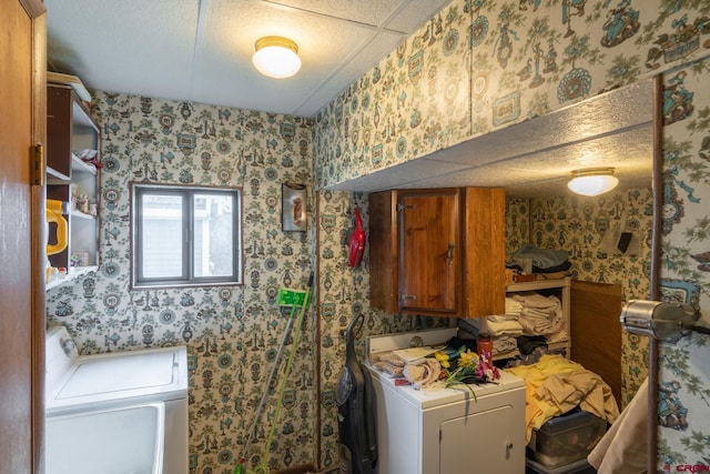 laundry room with washing machine and dryer and cabinets