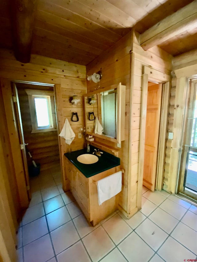 bathroom featuring wood walls, tile floors, and large vanity