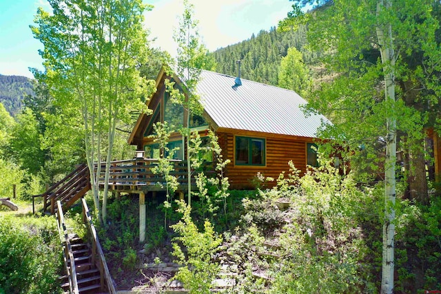 back of house with a wooden deck