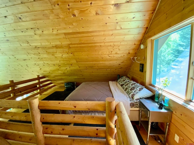 bedroom with vaulted ceiling, multiple windows, and wood ceiling