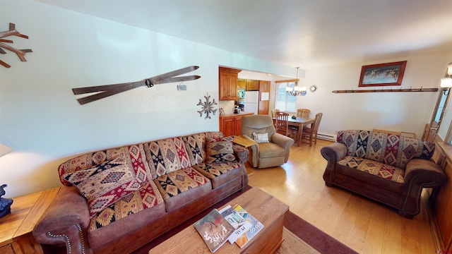 living room featuring a baseboard radiator and wood-type flooring