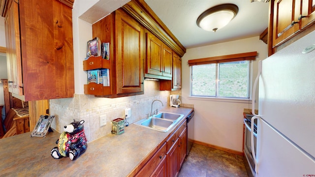 kitchen with stainless steel appliances, dark tile patterned flooring, backsplash, and sink