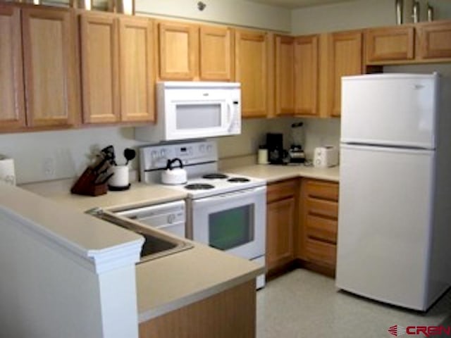 kitchen with white appliances and kitchen peninsula