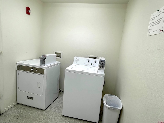 washroom with hookup for a washing machine, light tile floors, and washing machine and clothes dryer