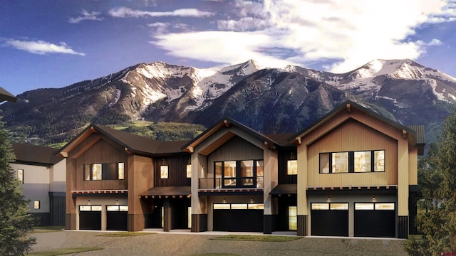 view of front of property featuring a garage and a mountain view