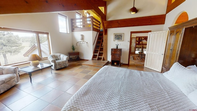 bedroom featuring light tile floors and a towering ceiling