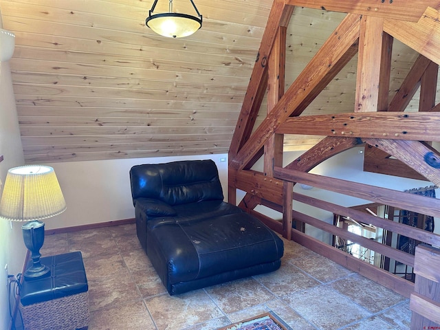 sitting room featuring wood walls, dark tile floors, wood ceiling, and vaulted ceiling