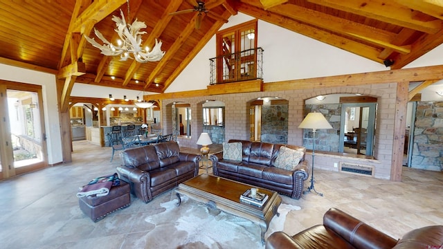 living room featuring beamed ceiling, wood ceiling, light tile floors, and ceiling fan with notable chandelier