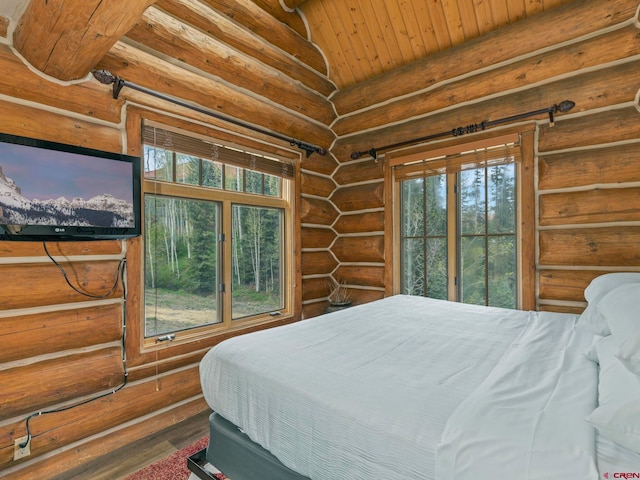 bedroom featuring dark hardwood / wood-style floors, wooden ceiling, rustic walls, and vaulted ceiling