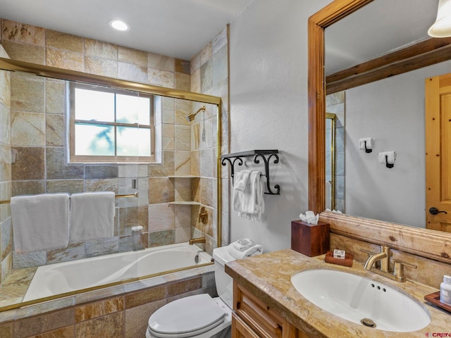 full bathroom with toilet, vanity, and combined bath / shower with glass door