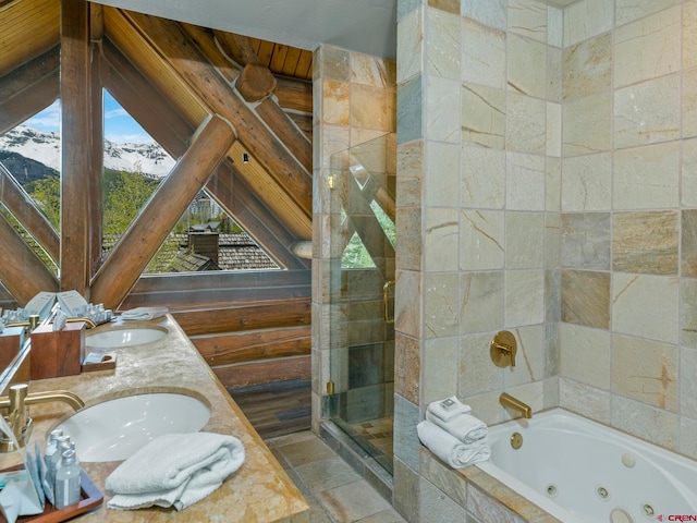 bathroom with shower with separate bathtub, wooden walls, a mountain view, tile floors, and dual vanity