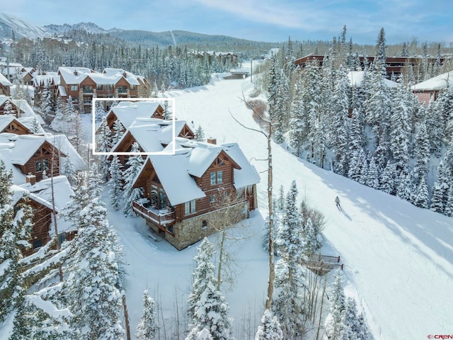 snowy aerial view with a mountain view