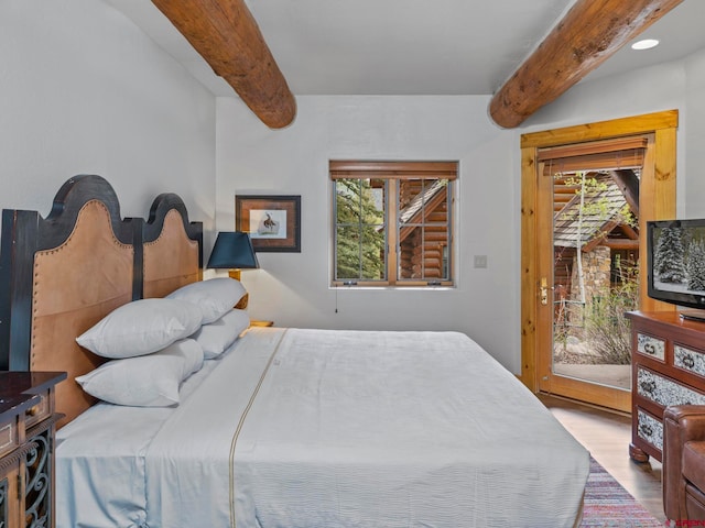 bedroom with beam ceiling, light hardwood / wood-style flooring, and access to exterior