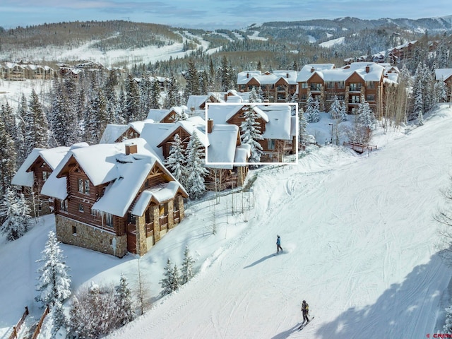 snowy aerial view with a mountain view