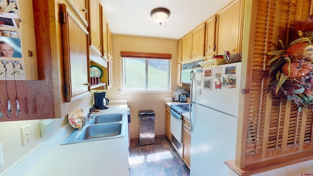 kitchen with white fridge, stainless steel range, and sink