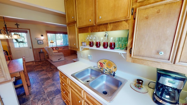 kitchen featuring sink, decorative light fixtures, and a chandelier