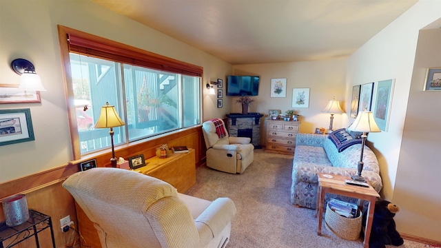 living room featuring wood walls and light colored carpet